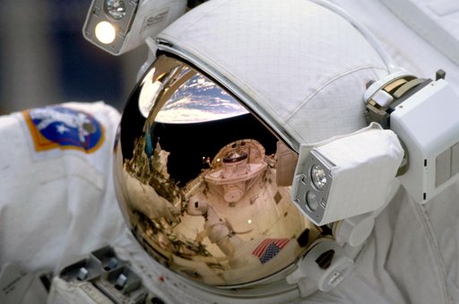 Reflection of payload bay in EMU helmet during EVA