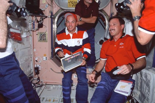 Sturckow signs the ISS ships log while Horowitz watches