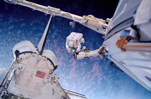 Barry on the RMS above the payload bay during EVA2