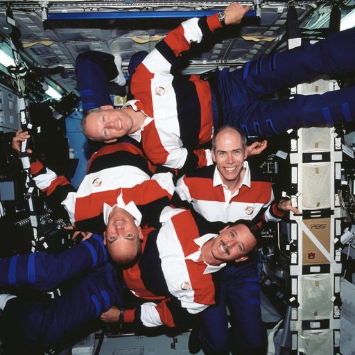 STS-105 crew in a group portrait in the ISS U.S. Laboratory/Destiny, pinwheel shape