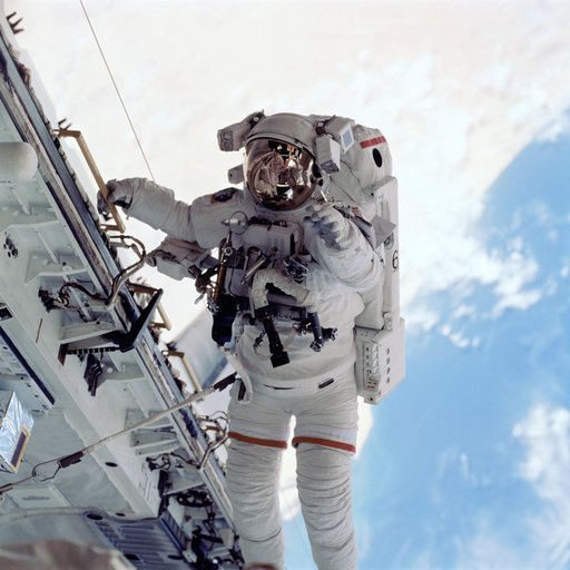 Barry translates along orbiter sill during EVA
