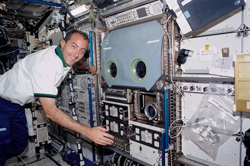 Perrin poses next to the MSG in the U.S. Laboratory during STS-111