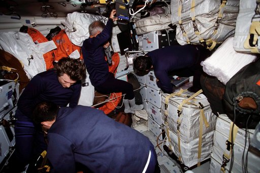 STS-111 UF-2 and EXP 4 Crewmembers work to secure Endeavour's MDK for landing