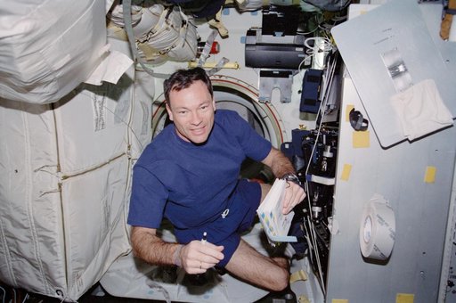 Lopez-Alegria in front of Endeavour's MDK hatch during STS-113