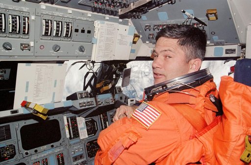 Lockhart, suited in LES for landing, in PLT's seat on Endeavour's FD during STS-113