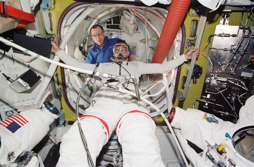 Lopez-Alegria during STS-113 EVA 2 pre-breathe ops and EMU don in Quest A/L