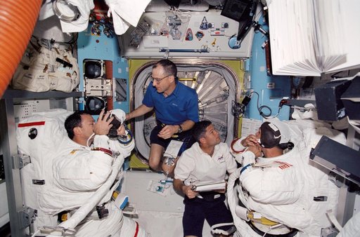 Herrington, Lopez-Alegria, Lockhart and Pettit during STS-113 EVA 2 EMU don in Quest A/L