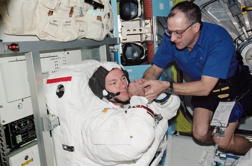 Lopez-Alegria and Pettit during STS-113 EVA 2 EMU don in Quest A/L