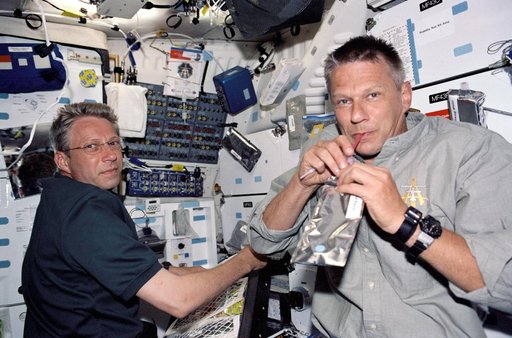 Sellers and Reiter on the MDK at meal time during STS-121