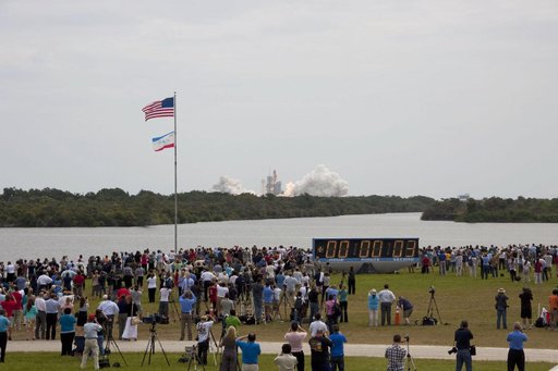 Spectators watch the Final Launch of STS-135 Atlantis
