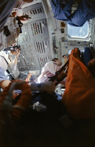 STS-33 crewmembers on OV-103's aft flight deck photograph Earth observations