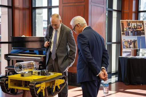 NASA's Douglas Terrier and David Steitz Investigate a Rover at Arkansas' Harding University