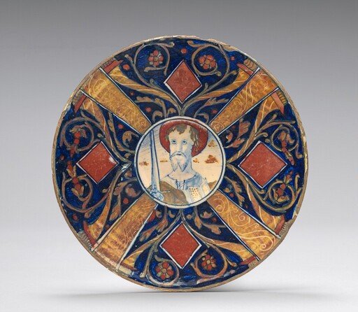 Small flat plate with border of cornucopias, scrollwork, and lozenges in four sections; in the center, a bust of Saint Paul with raised sword