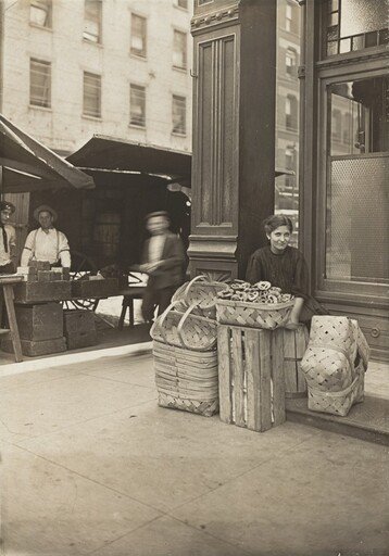 Lena Lochiavo - 11 years old, basket (and pretzel) seller, at Sixth Street Market in front of saloon entrance, Cincinnati, Ohio