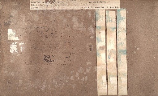 Descending step-ladder, turning around, rock in hand