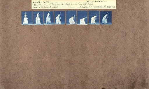 Stooping and lifting handkerchief, parasol in left hand