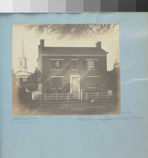 Two storey brick house with church