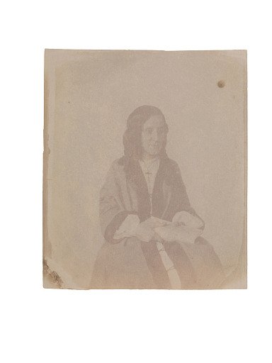 Portrait of a young woman wearing a rosary or cross