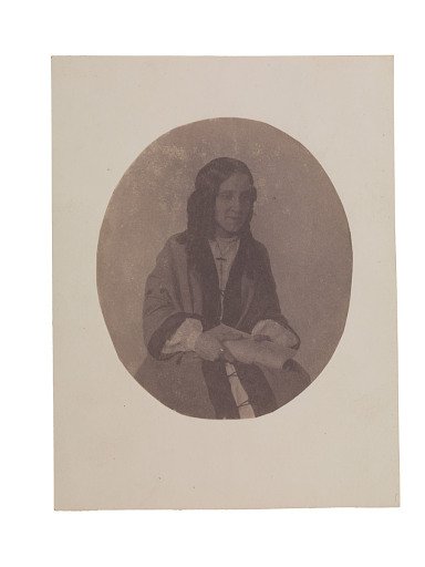 Portrait of a young woman wearing a rosary or cross