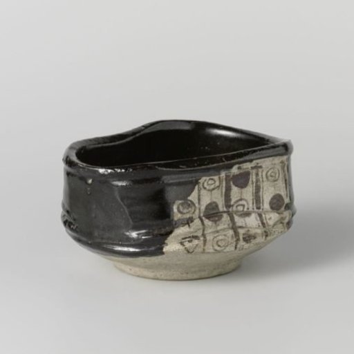 Tea bowl with a black glaze and geometrical patterns in panels