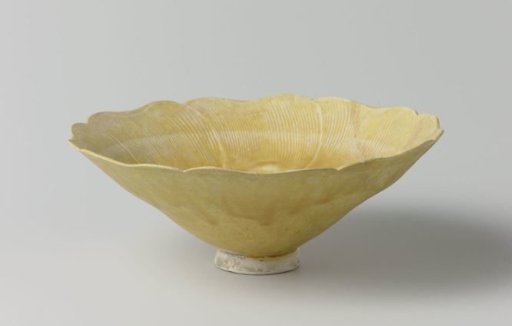 Bowl in the shape of a flower with a yellow glaze
