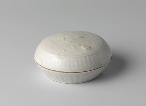 Round box with a flower spray in relief and fluted sides