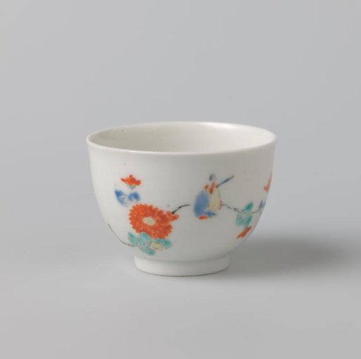 Round cup and lobed saucer with flower spray and bird