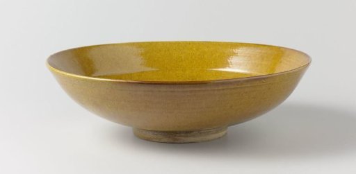 Saucer-dish with an ochre yellow glaze