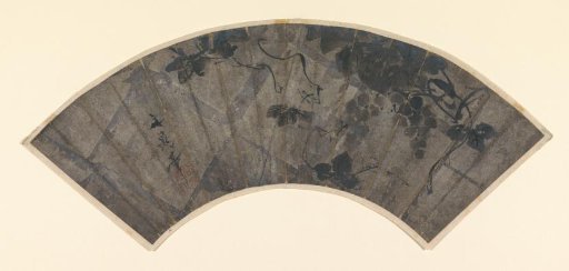 Fan leaf with grapes and vine tendrils