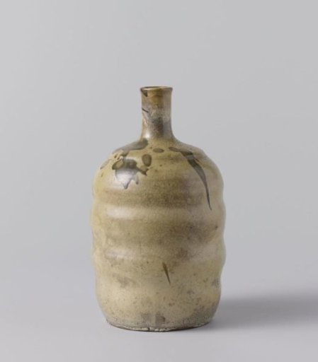 Sake bottle with a cream colored glaze with green spots