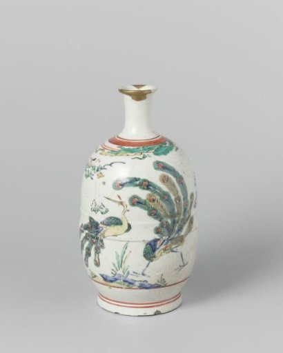 Sake bottle with two peacocks near a rock with a flowering plant