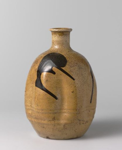 Ovoid sake bottle with a yellow glaze and brown marks