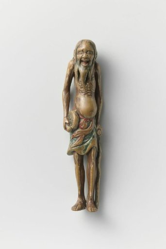 Netsuke in the form of a saint with drum and staff