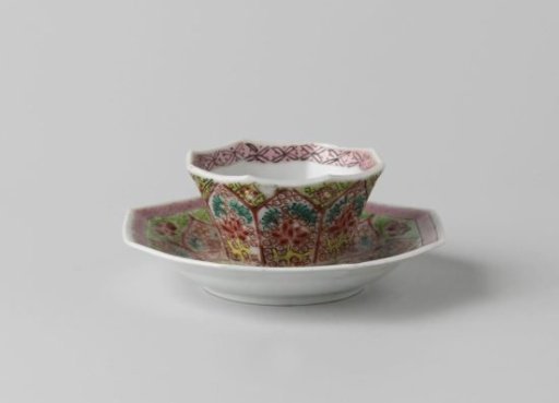 Octagonal cup and saucer with foral scrolls in petal-shaped panels