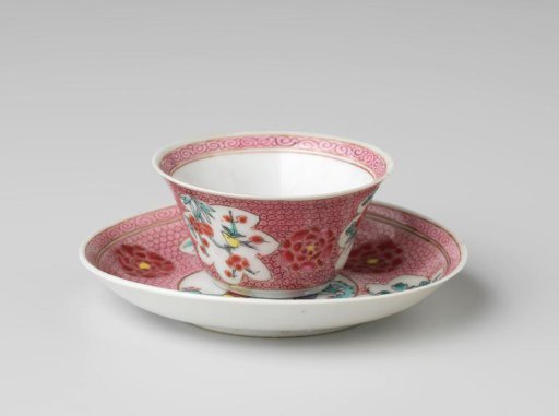 Cup and saucer with a woman and boy in a landscape and flower sprays on diaper-pattern