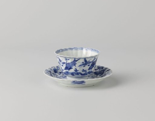 Bell-shaped cup and saucer with fish, crabs and water plants