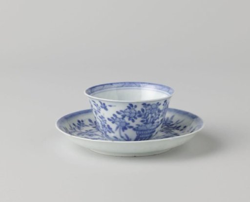 Cup and saucer with a bird of prey, flowerbasket and plants