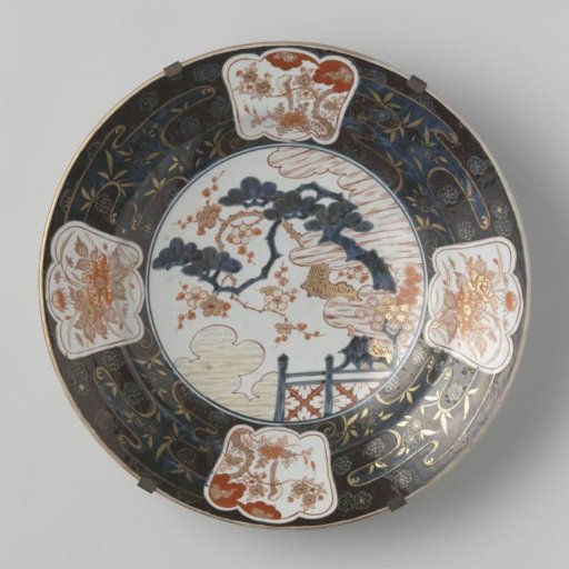 Dish with a prunus tree behind a fence and flower sprays
