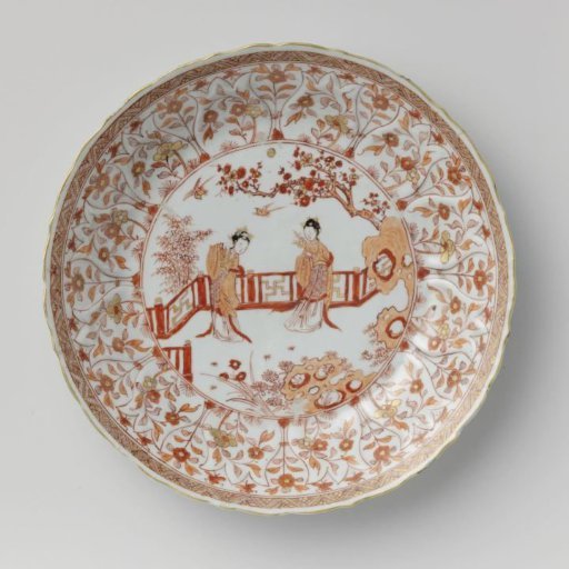 Saucer-dish with two women beneath a prunus in a fenced garden
