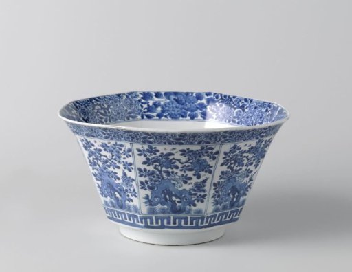 Octagonal bowl with flowering plants near a rock