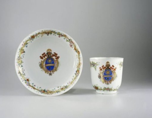 Cup with handle and saucer with a coat of arms and bamboo border with floral scrolls