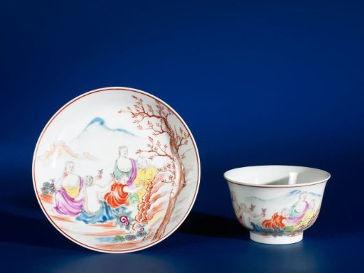 Bell-shaped cup and saucer with European figures in a landscape