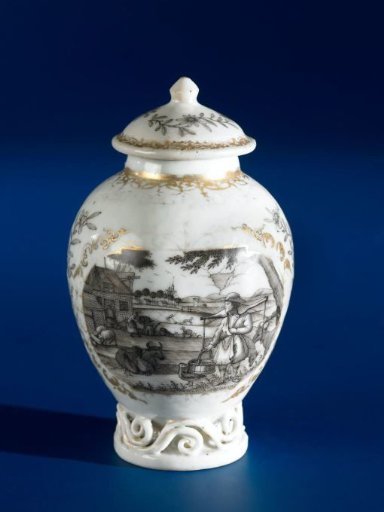 Ovoid tea caddy with a European country scene in two panels with flower sprays in between