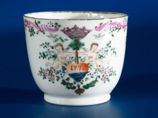 Cup with handle with a date in a crowned heart supported by angels