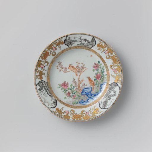 Plate with two birds on a rock with flowering plants