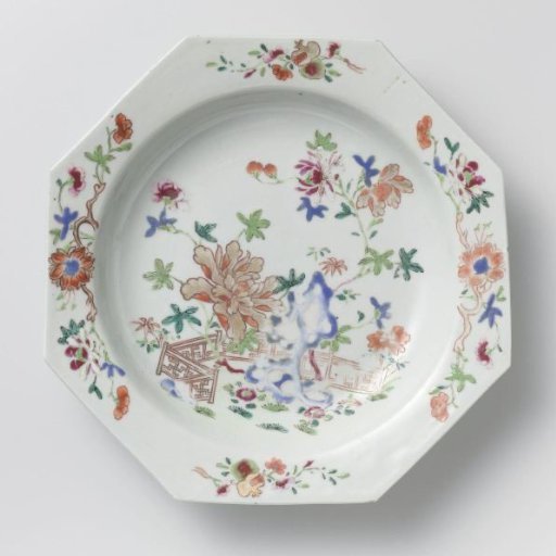 Octagonal soup plate with a rock, flowering plants and a fence