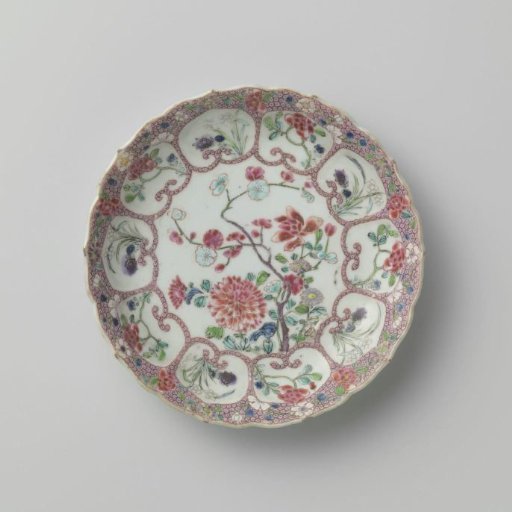 Saucer with flowering plants and flower sprays in moulded petal-shaped panels on diaper pattern