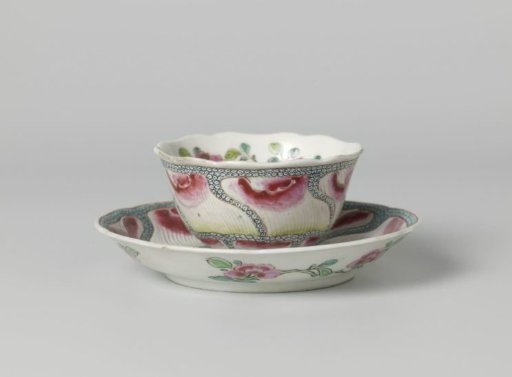 Bell-shaped cup and saucer with undulating flower petals on diaper pattern and flower sprays