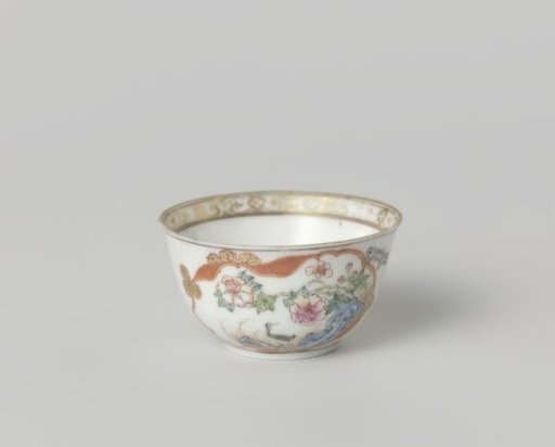 Bell-shaped cup with crane near a peony plant and rock