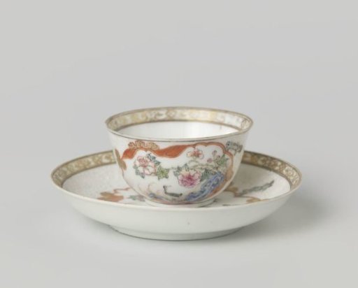 Bell-shaped cup and saucer with crane near a peony plant and rock
